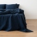 Ropa de cama de lino lavado azul marino sobre una cama